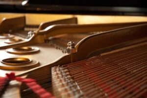 the inside of a grand piano with strings